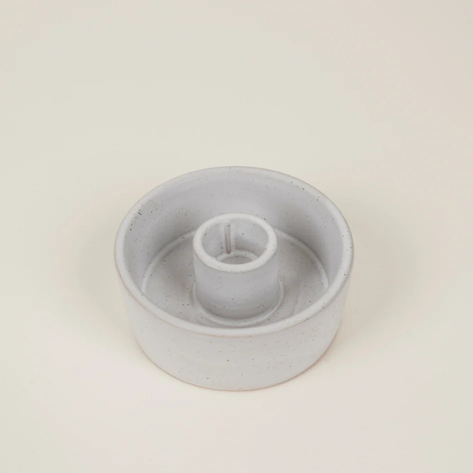 Gray plastic component on a beige background