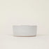 Speckled gray ceramic bowl on a beige background