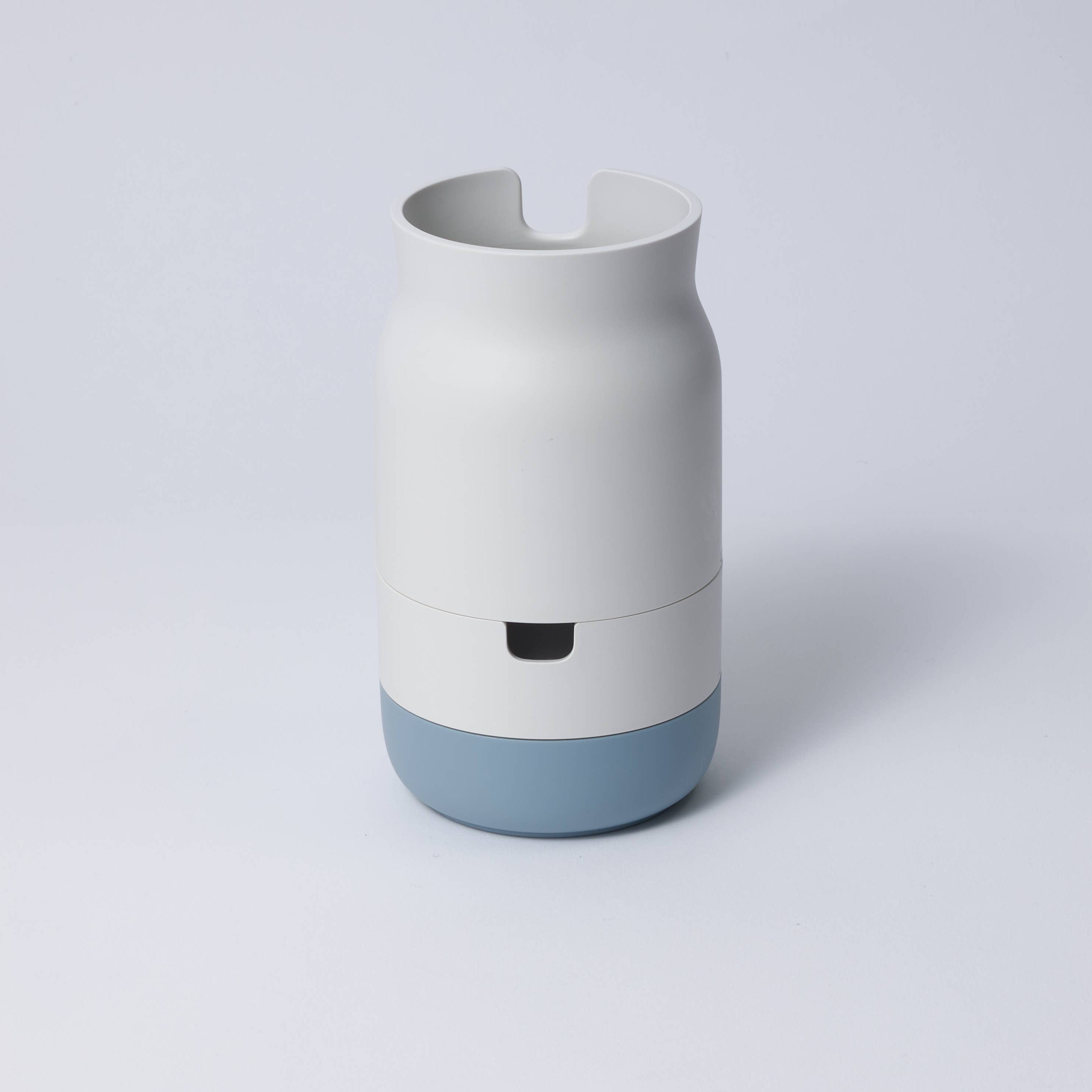 A collection of stackable porcelain-like organizers in various colors, containing pens and other desk items.