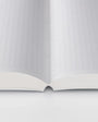 Open notebook with grid-patterned pages on a white background