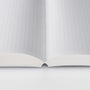 Open notebook with grid-patterned pages on a white background