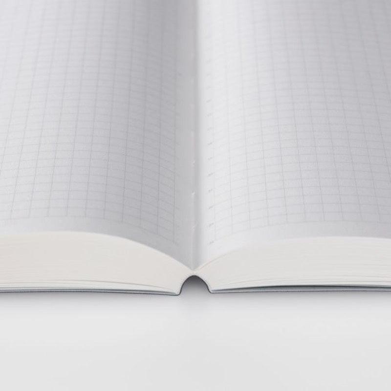 Open notebook with grid-patterned pages on a white background