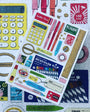 Sticker sheet with stationery items on a puzzle background