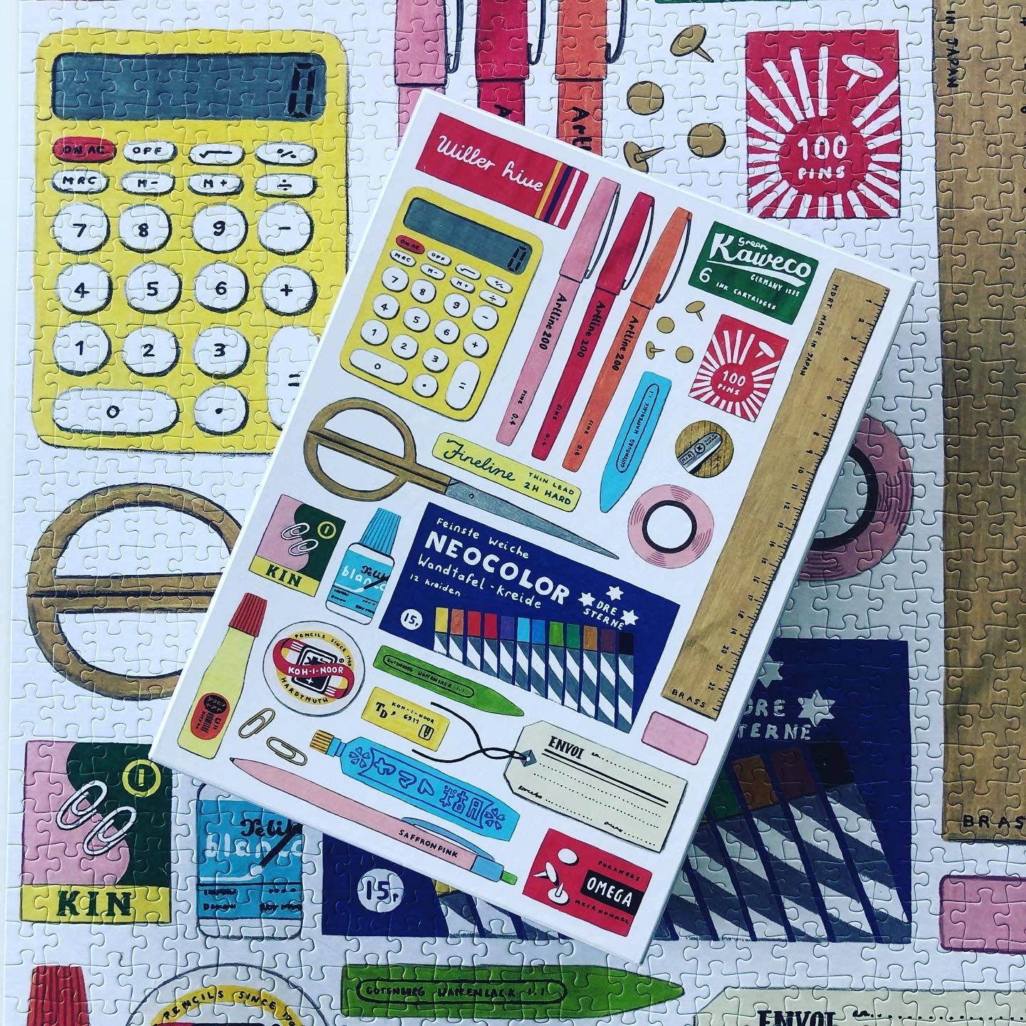 Sticker sheet with stationery items on a puzzle background