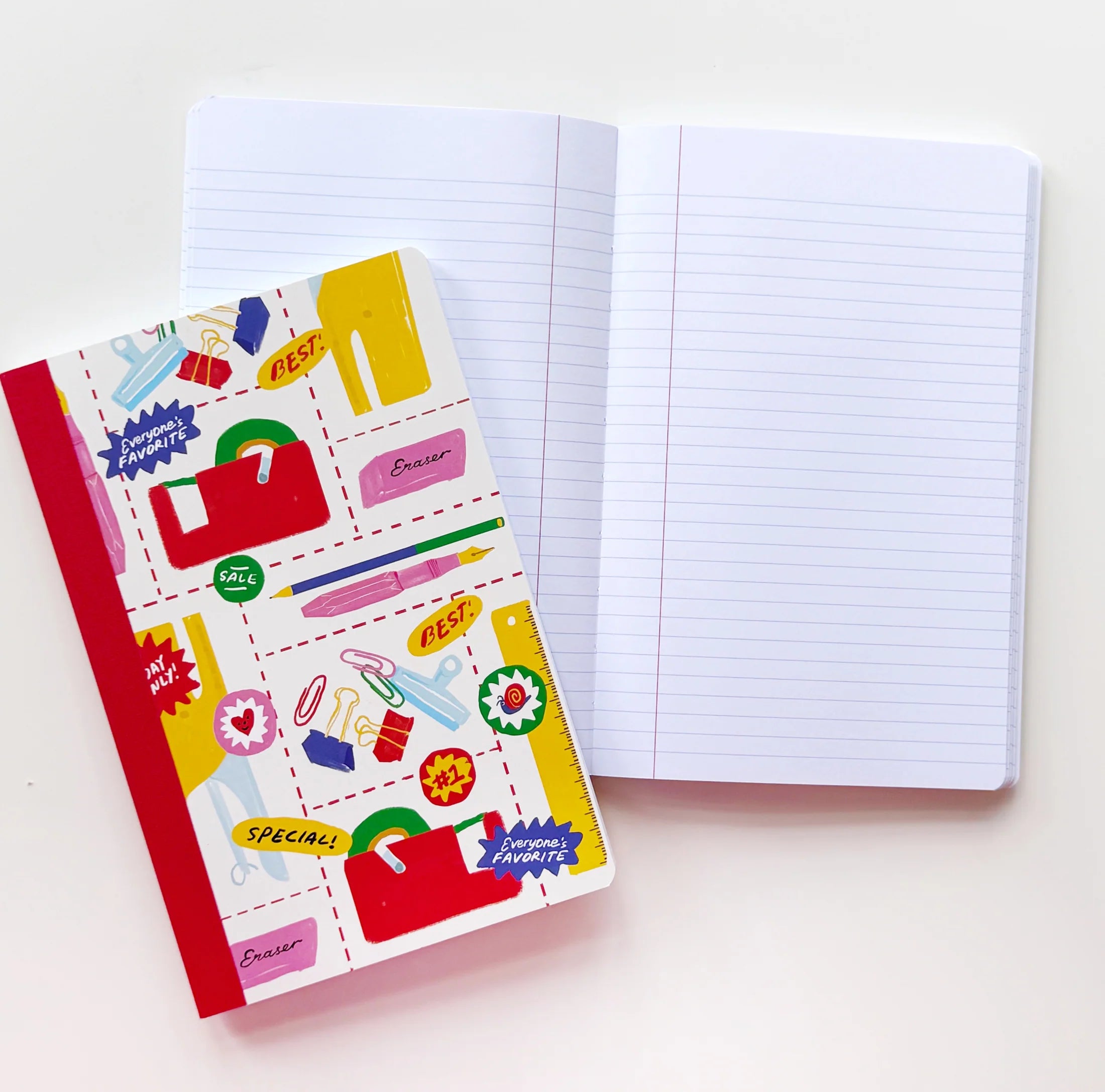 A decorated hardcover notebook with a colorful illustrated cover lies next to an open lined notebook on a plain white background.