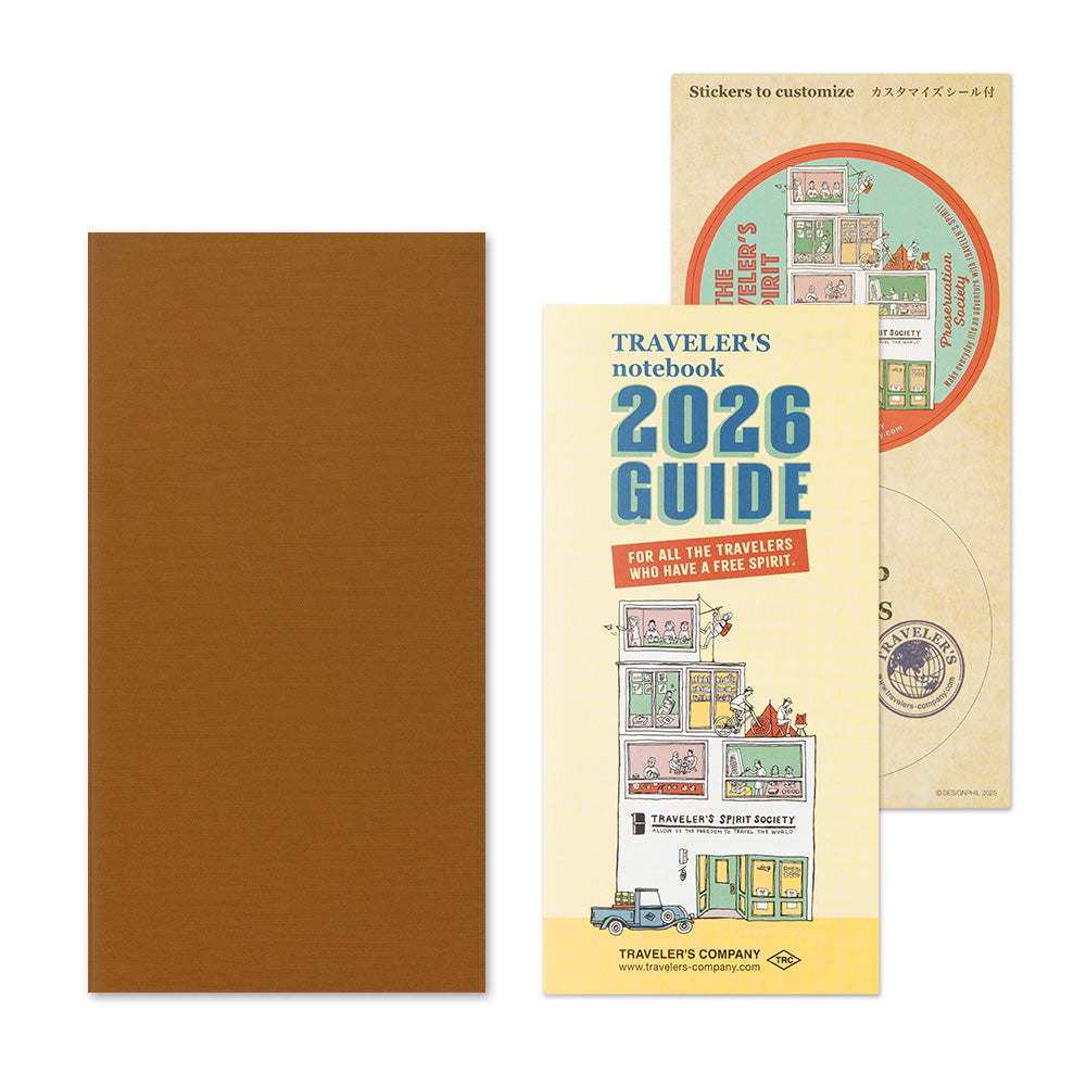 Brown notebook with a yellow cover featuring 'Traveler's notebook 2026 Guide' and a circular sticker on a white background.