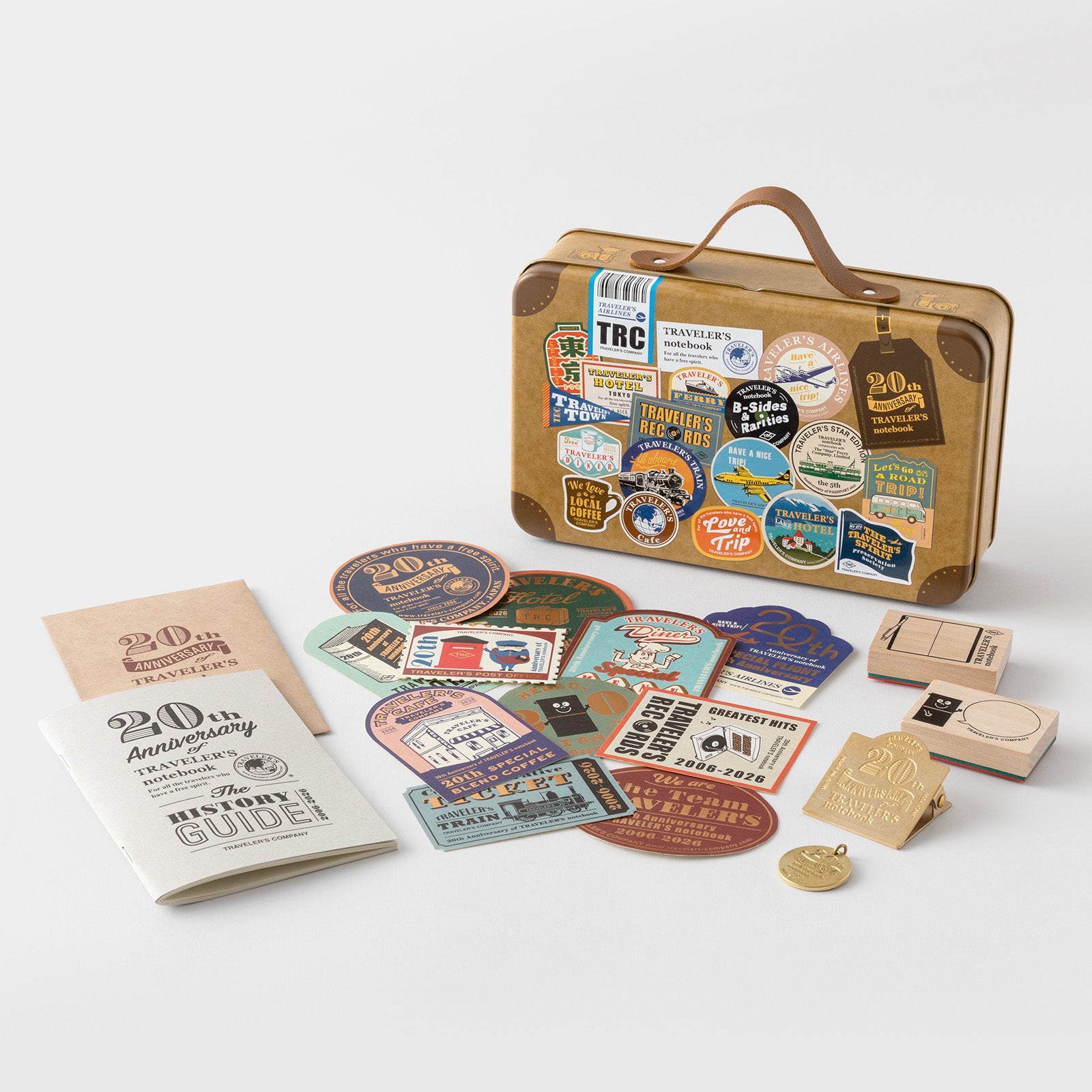 Travel-themed kit with stickers, notebook, and decorative items on a white background