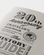 Traveler's notebook with '20th Anniversary' text and logo on a white background