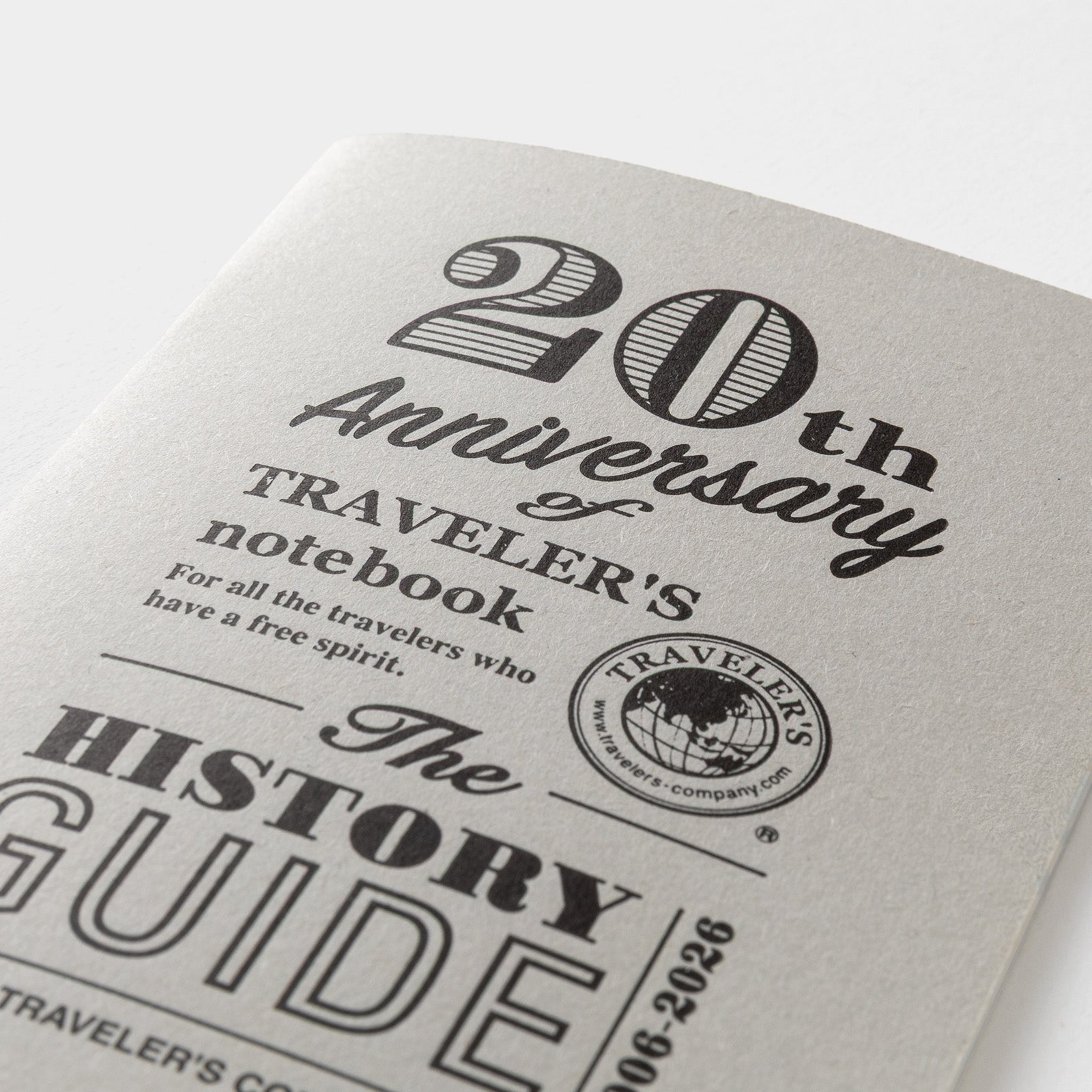 Traveler's notebook with '20th Anniversary' text and logo on a white background
