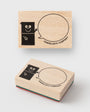 Two wooden stamps with cartoon character and speech bubble design on a white background, branded 'Traveler's Company'.