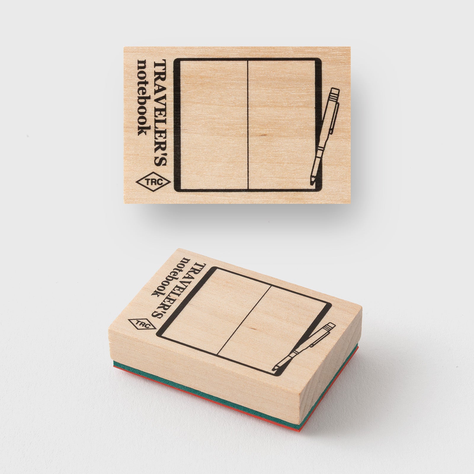 Two wooden stamps with 'Traveller's notebook' design on a white background