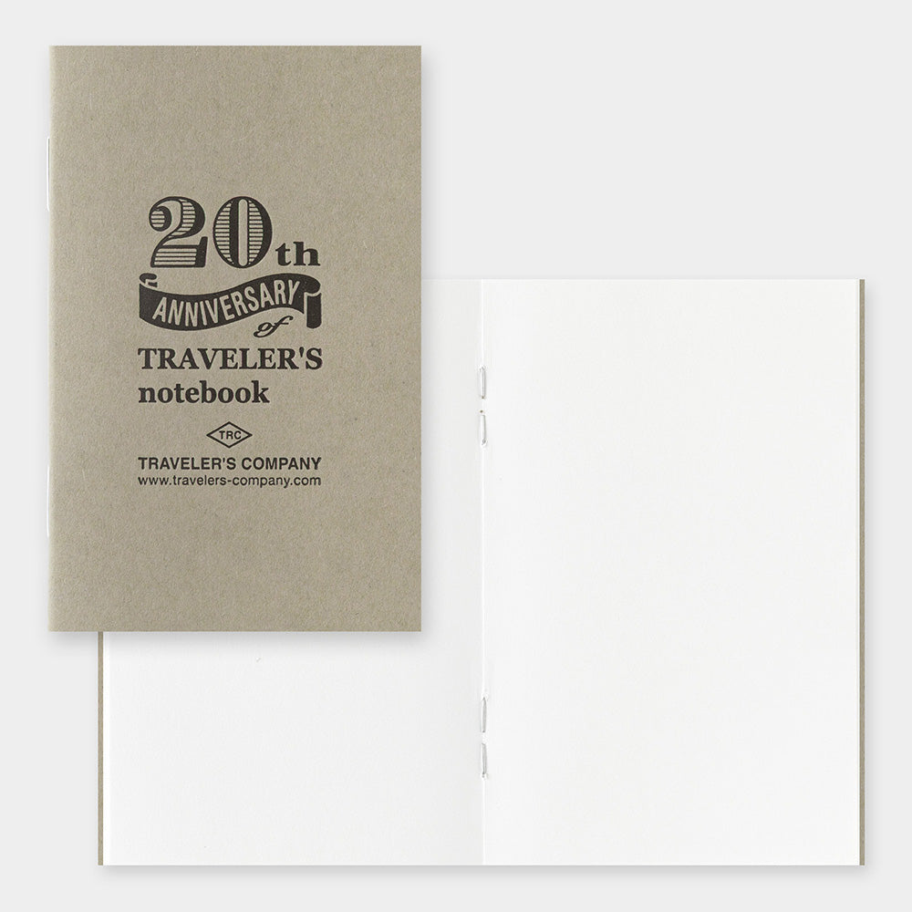 Beige notebook with '20th Anniversary of Traveler's notebook' text on a white background
