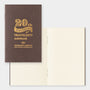 Brown notebook with gold text '20th Anniversary Traveler's notebook' on a white background