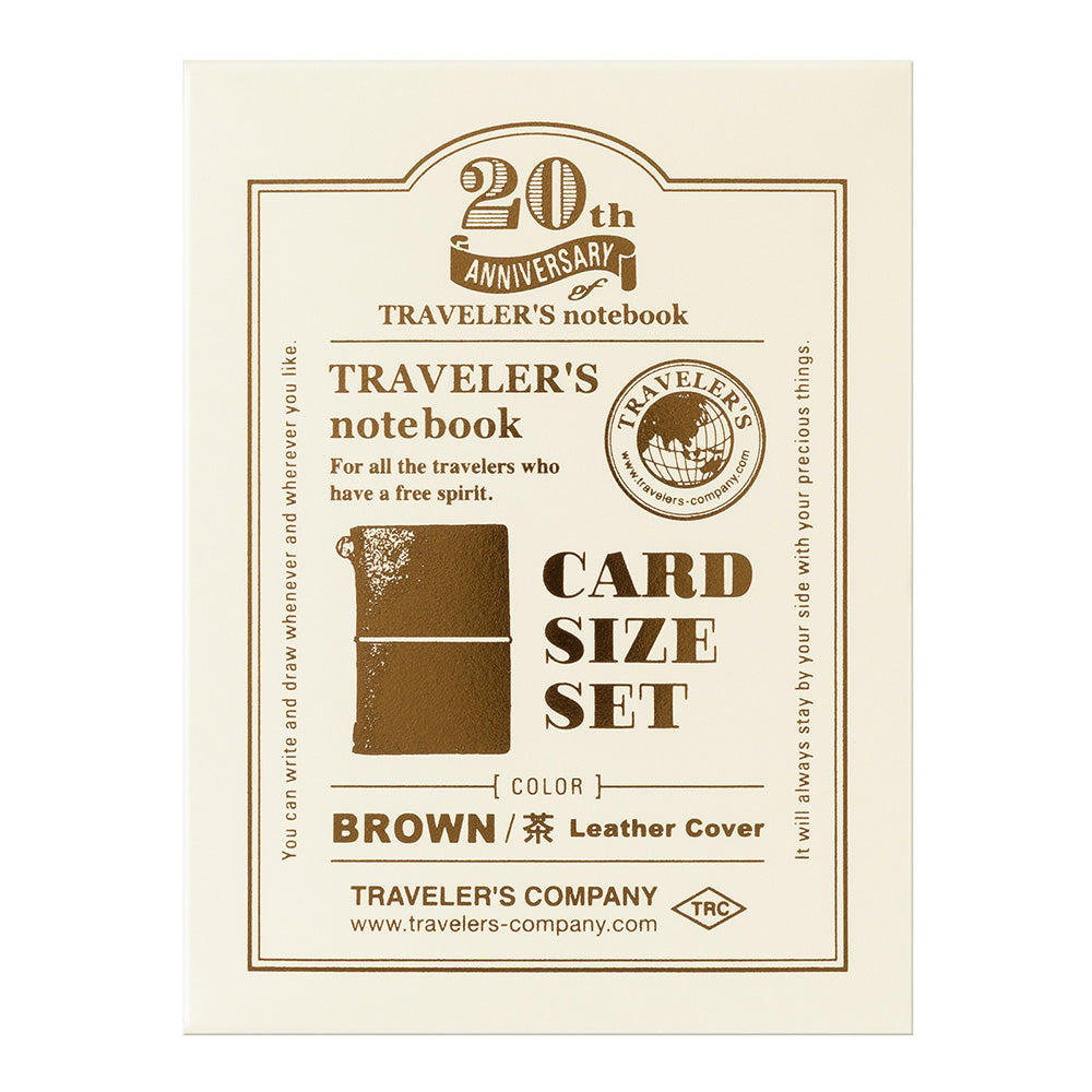 Traveler's notebook card size set packaging with brown leather cover on a beige background