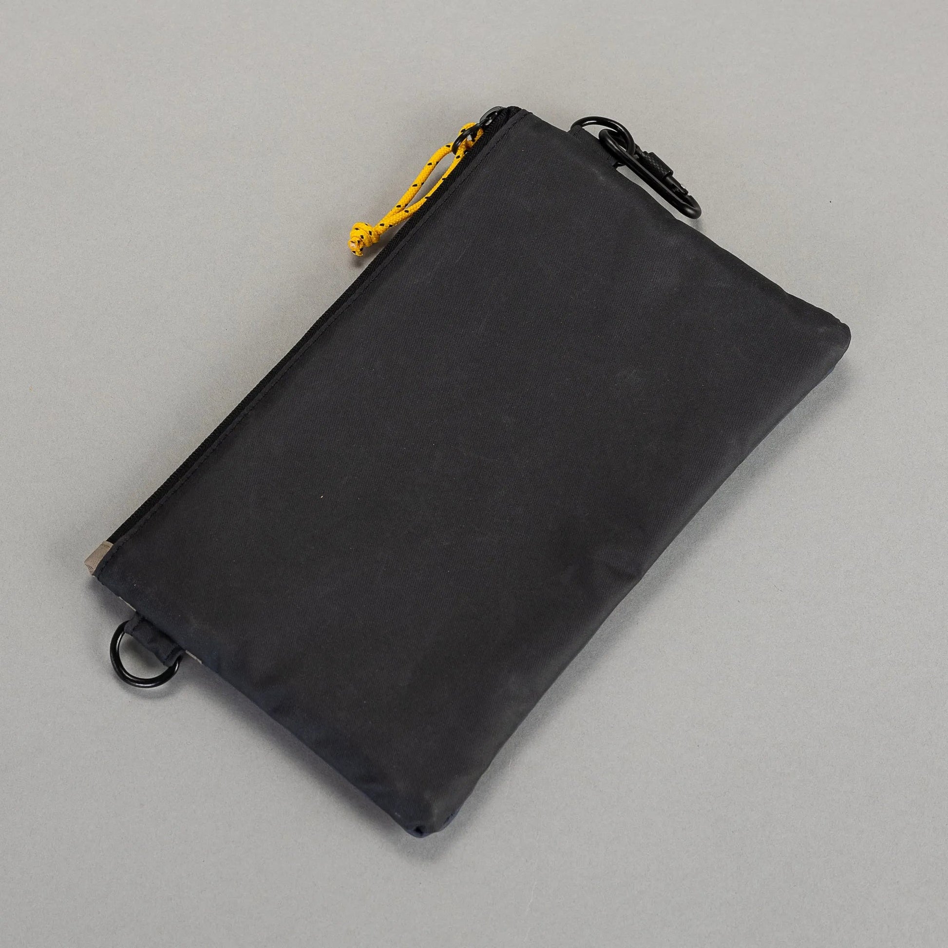 Black drawstring pouch on a gray background