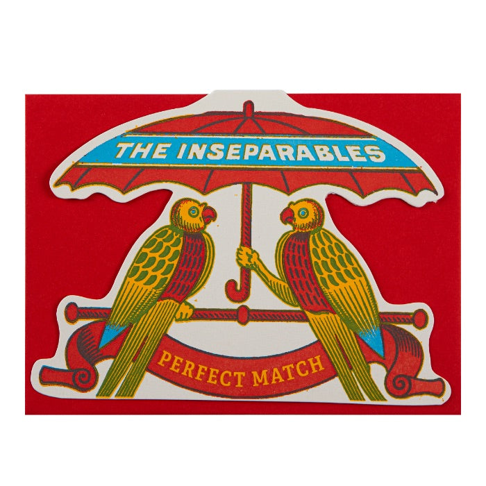 Decorative card with two parrots under an umbrella and 'The Inseparables' text on a red background.