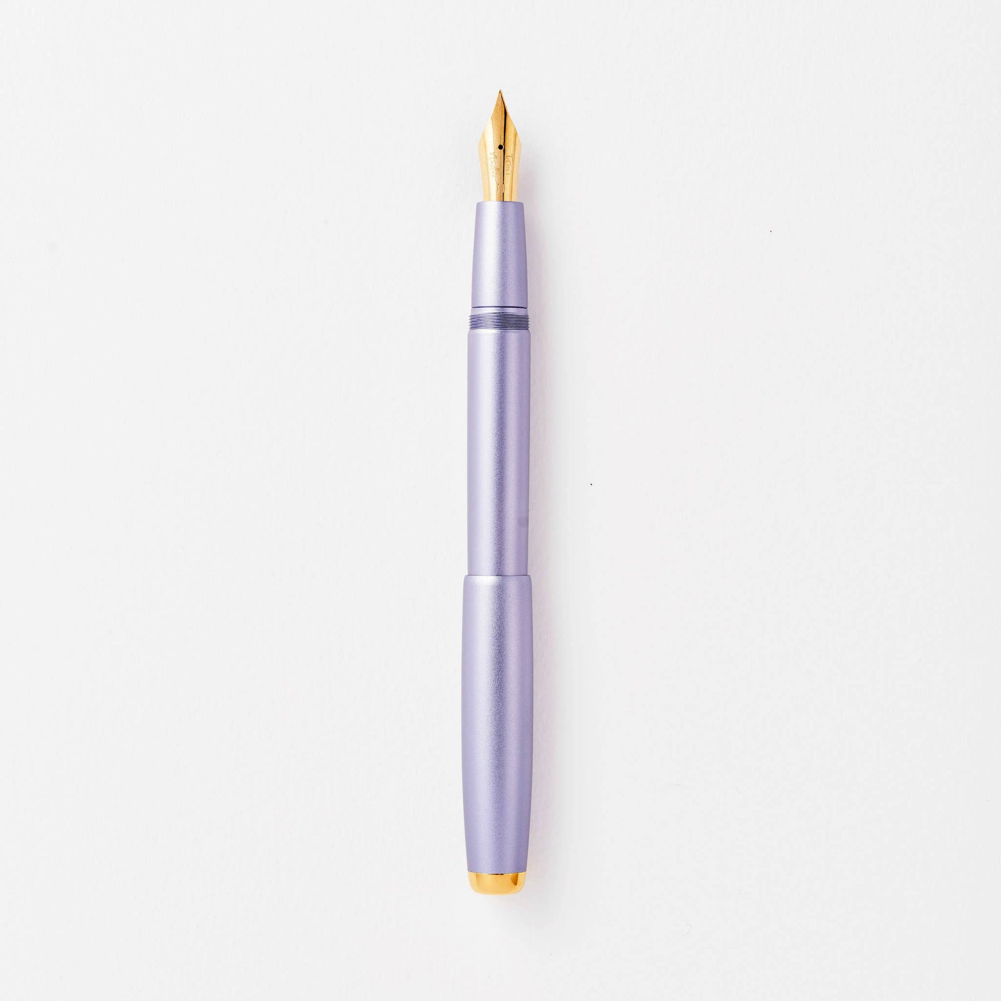 Lilac fountain pen with gold accents on a white background