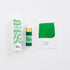 Green ink bottle with packaging and color swatch on a white background