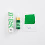 Green ink bottle with packaging and color swatch on a white background