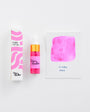 Pink ink bottle with packaging and color swatch on a white background
