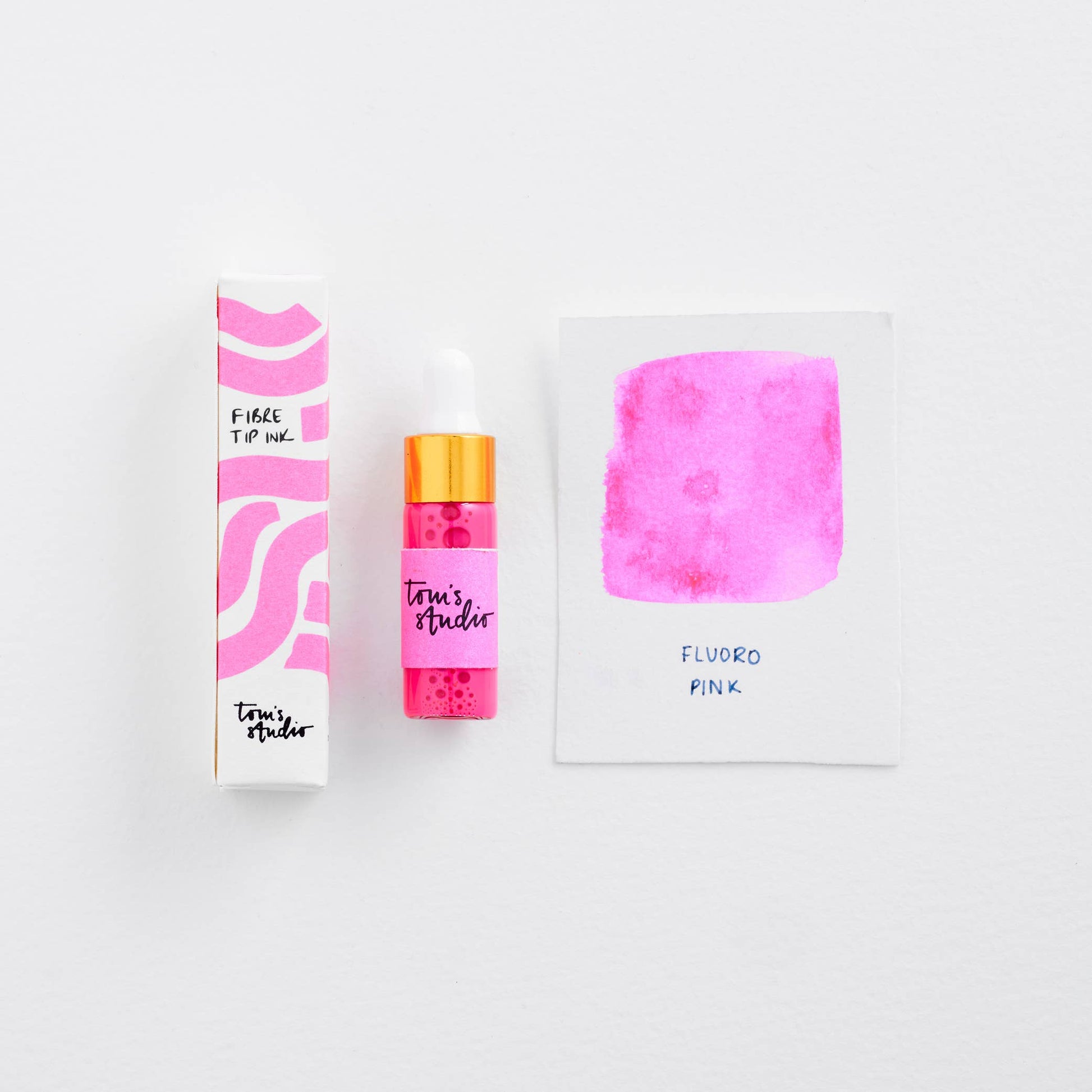 Pink ink bottle with packaging and color swatch on a white background