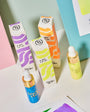 Colorful ink tubes and boxes on a pastel background
