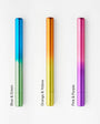 Three gradient-colored pens on a white background