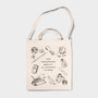 Tote bag with illustrations and text on a light gray background
