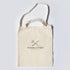 Beige tote bag with 'TOOLS TO LIVE BY' logo on a light gray background