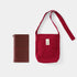 Red shoulder bag with a matching pouch on a white background