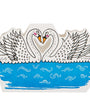 Decorative paper cutout of two swans on water with a blue background