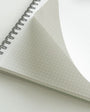 Open notebook with grid paper on a white background