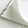 Open notebook with grid paper on a white background