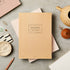 Ochre colour notebook on a table
