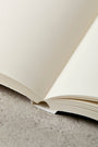 Notebook open laying flat with plain paper