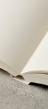 Notebook open laying flat with plain paper