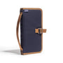 Navy blue and brown bag with strap on a white background