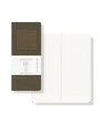 Two notebooks, one open showing grid pages and the other closed with a label, on a white background.