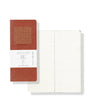 Notebook with red cover and white pages on a white background