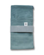 Teal fabric roll with a label on a white background
