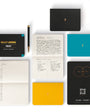 Collection of bullet notebooks and a pen on a white background