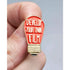 Light bulb-shaped pin with 'Develop Your Own Film' text held between fingers