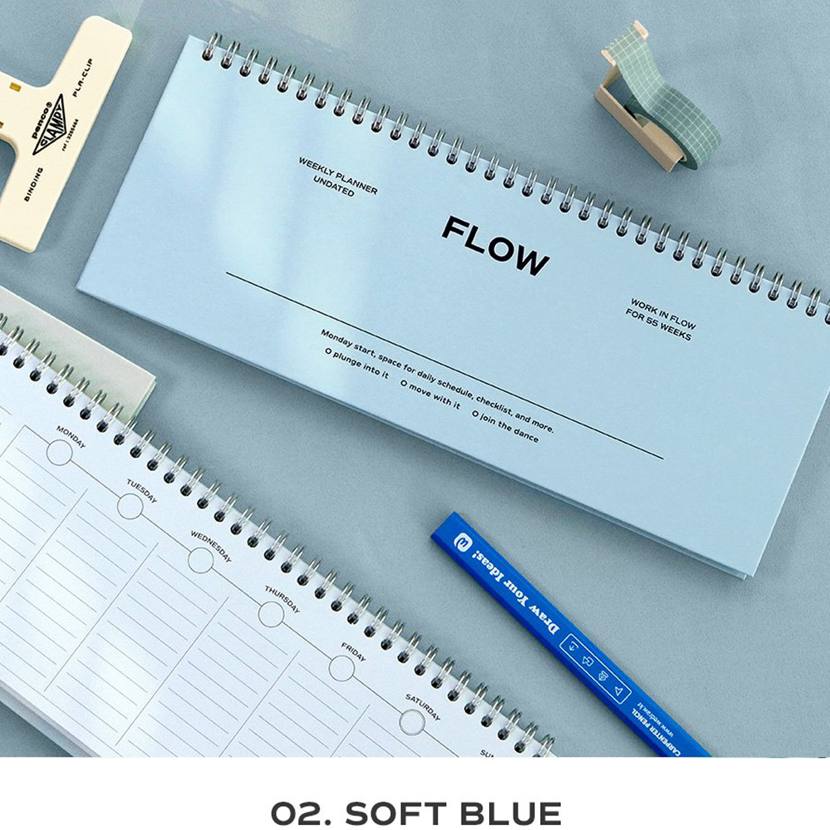A spiral-bound planner pad in soft blue labeled 'FLOW' is shown on a light blue surface with other stationery items around it, including a white lined notepad, a blue pen, and washi tape. Text at the bottom reads 'O.