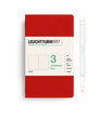 Red notebook with white label featuring Leuchtturm1917 branding and a pen on a white background
