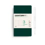 Green notebook with white label and pen on a white background