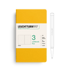 Yellow notebook with white label and pen on a white background