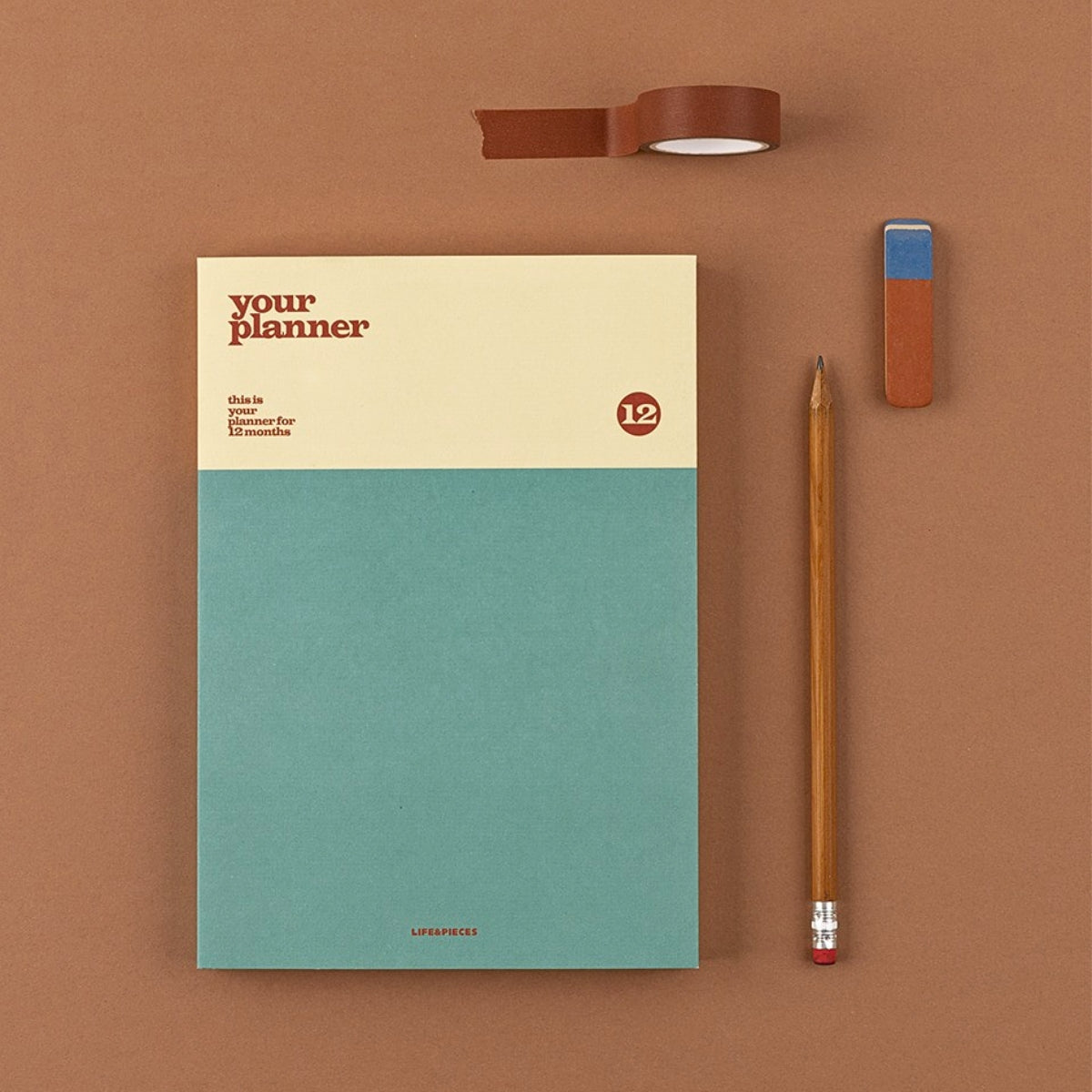 Notebook with a pencil and eraser on a brown background