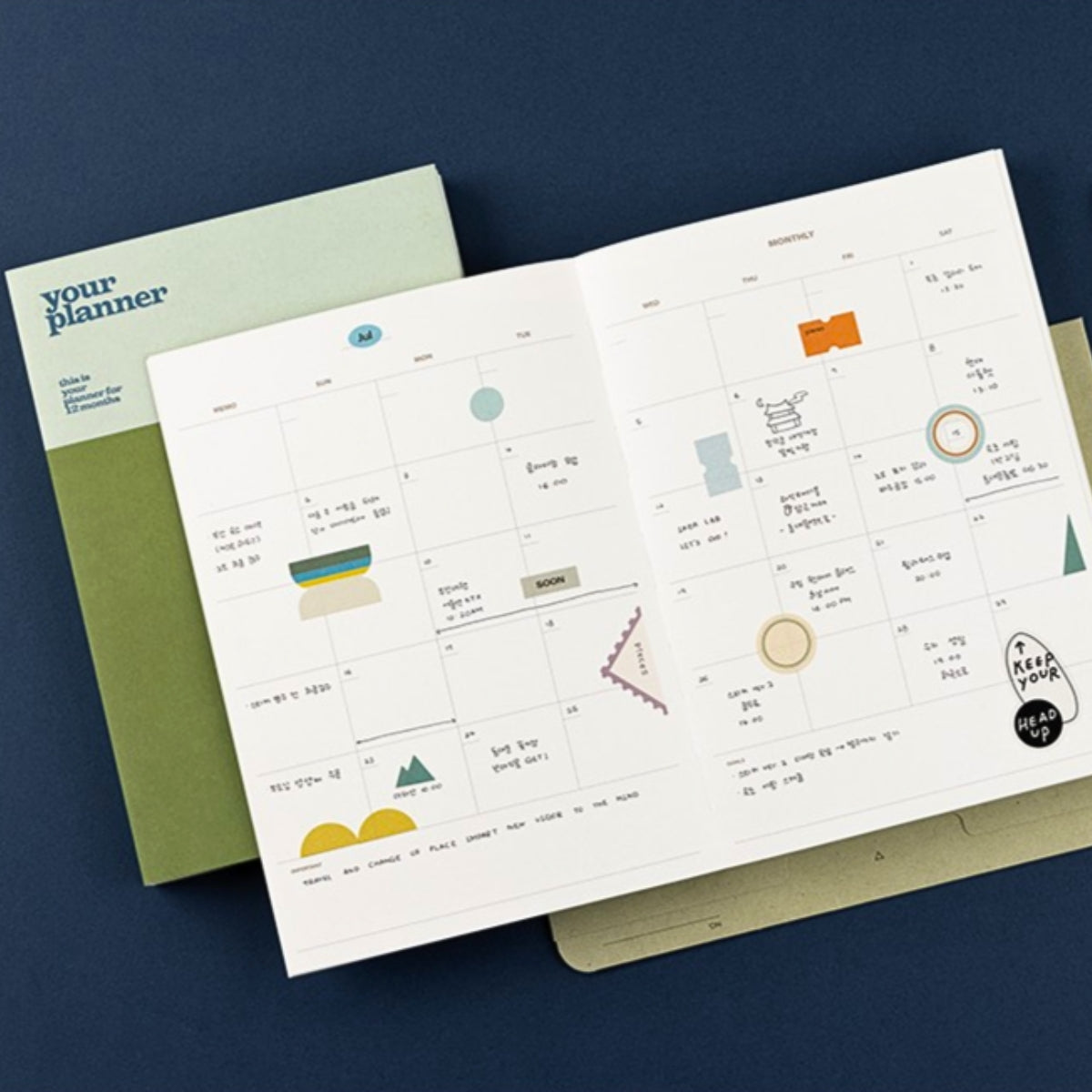 Open planner with geometric illustrations on a blue background