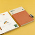 Notebook with a pen on a yellow background