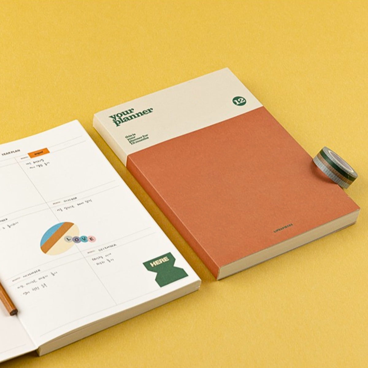 Notebook with a pen on a yellow background